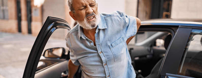 patient with back pain in need of auto accident injury care in Coppell